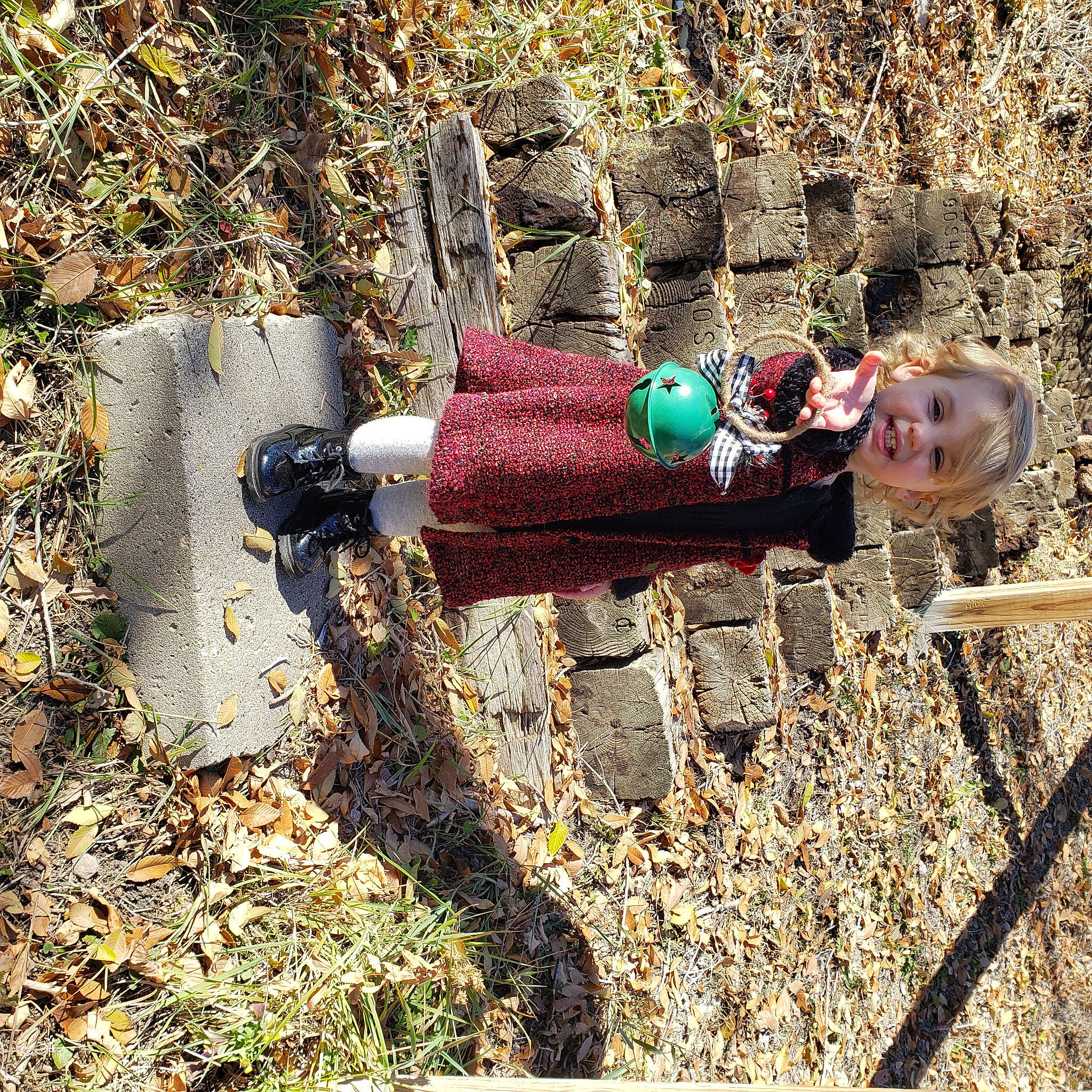 Kiya is registered to the contest to win money with this photo: adventure, grass, landscape, leisure, people_in_nature, person, recreation, shadow, smile, soil, toddler, wood