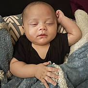 Knox is registered to the contest to win money with this photo: baby, black_clothing, blanket, child, closed_eyes, couch, cozy, cute, face, hand, home, infant, peaceful, portrait, relaxation, resting, sleeping, soft_texture, toddler, young