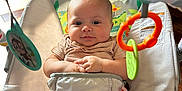 Knox joined the competition — help win amazing prizes! baby, infant, bouncer, toys, colorful, indoor, child, cute, smiling, seat, play, hands, face, legs, clothing, comfort, expression, closeup, happy, person