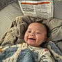 Knox is registered to the contest to win money with this photo: baby, blanket, smile, face, infant, cozy, playpen, fabric, soft, happy, child, clothing, cute, indoors, person, head, comfort, resting, texture, warm