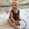 Adalynn joined the competition — help win amazing prizes! baby, child, smiling, sitting, blanket, floral_pattern, wreath, hair_bow, indoor, carpet, couch, cute, happy, person, infant, skin, head, feet, hand, playful