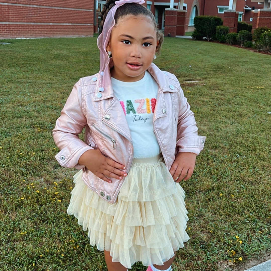 Nylah joined the competition — help win amazing prizes! child, clothing, coat, face, female, footwear, girl, grass, head, jacket, lawn, neighborhood, pants, person, photography, plant, portrait, shoe, skirt, sneaker
