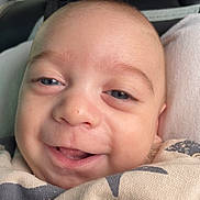 Nheylan a rejoint le concours — aidez-le/la à gagner de superbes lots ! baby, infant, newborn, face, smile, closeup, car_interior, car_seat, blanket, eyes, cheeks, mouth, head, skin, happy, cozy, portrait, seatbelt, fabric, gaze