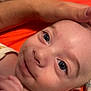 Nheylan a rejoint le concours — aidez-le/la à gagner de superbes lots ! baby, infant, child, close_up, portrait, eyes, smile, cheek, forehead, skin, hand, adult_hand, arm, orange_background, sheet, diaper, onesie, lying_down, cute, gaze