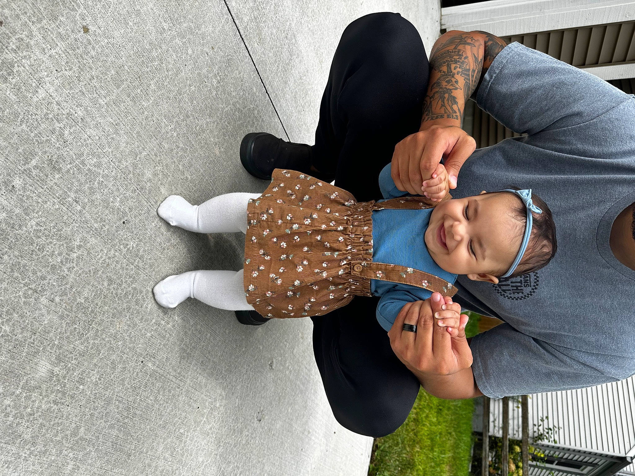 Amora is registered to the contest to win money with this photo: child, comfort, elbow, finger, flooring, fun, gesture, grass, hand, happy, hat, headwear, human_leg, joy, knee, nail, pattern, person, sitting, sleeve