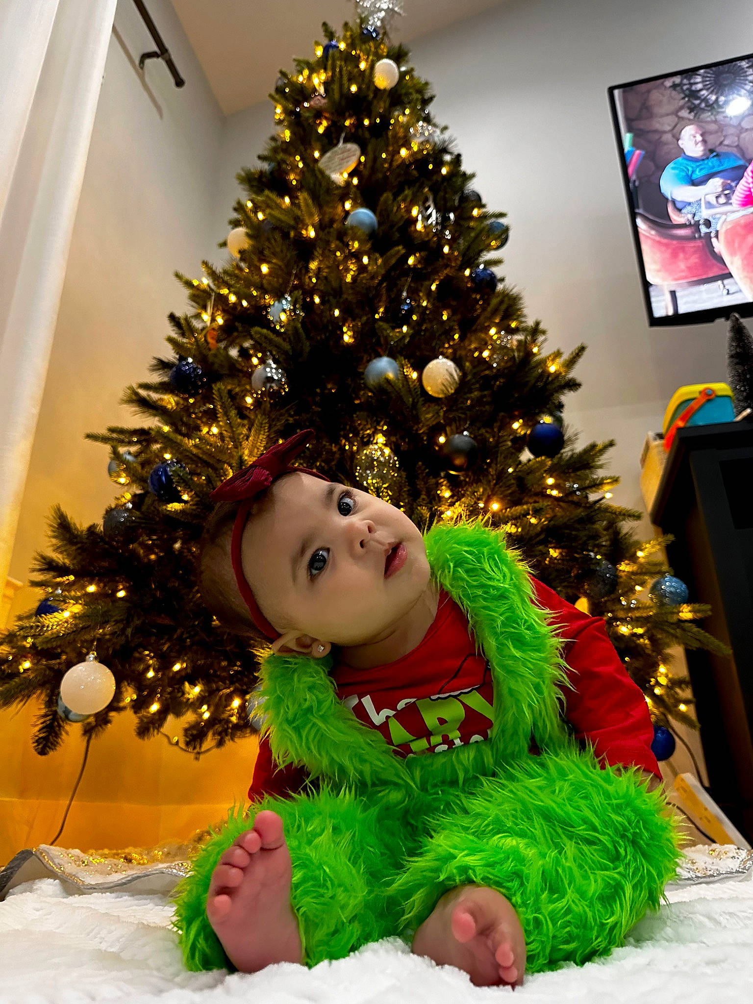 Amora joined the competition — help win amazing prizes! christmas, christmas_decoration, christmas_eve, christmas_ornament, christmas_tree, conifer, event, evergreen, happy, headwear, holiday, holiday_ornament, interior_design, ornament, person, plant, red, room, snapshot, toddler