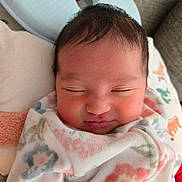 Juliana joined the competition — help win amazing prizes! baby, newborn, sleeping, blanket, floral_pattern, face, head, cushion, soft, resting, peaceful, infant, wrapped, cozy, indoors, child, portrait, cute, warm, young