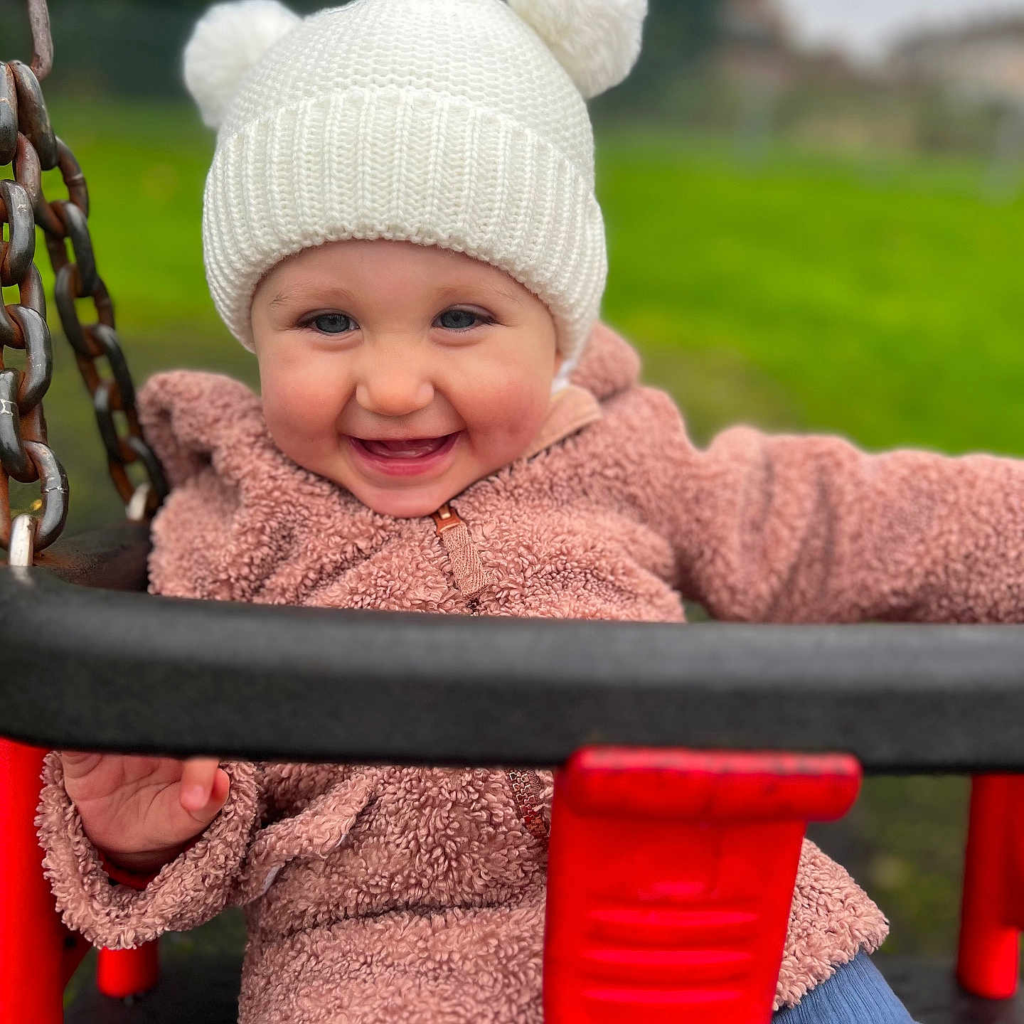 Luna is registered to the contest to win money with this photo: baby, beanie, cap, clothing, coat, face, grass, happy, hat, head, jacket, outdoorplayarea, outdoors, person, photography, plant, playarea, portrait, smile, toy