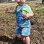 Hadleigh joined the competition — help win amazing prizes! baby, barefoot, casual_clothing, child, curious_expression, daylight, denim_overalls, dirt, grass, green_shirt, house, nature, outdoor, person, ponytail, spring, standing, sunny, toddler, trees