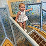 Hadleigh is registered to the contest to win money with this photo: active, child, colorful, curly_hair, dress, exploring, fun, happy, indoor, patterned_panels, person, play_area, playground, railing, rope_bridge, smiling, toddler, white_sandals, wooden_floor, young_child