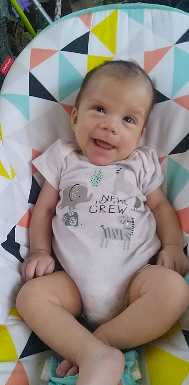 Leonardo is registered to the contest to win money with this photo: baby, baby_toddler_clothing, cheek, comfort, eye, face, facial_expression, finger, happy, head, joy, lip, person, pink, skin, sleeve, smile, stomach, t_shirt, textile