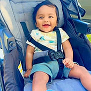 Krishav joined the competition — help win amazing prizes! baby, stroller, smiling, child, happy, seatbelt, blue_blanket, outdoor, infant, clothing, child_safety, cute, portrait, baby_clothes, seated, sunlight, young_child, baby_girl, comfort, casual