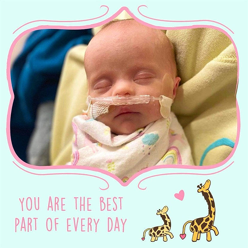 Maizie is registered to the contest to win money with this photo: baby, baby_toddler_clothing, bib, cheek, comfort, ear, eye, eyebrow, font, happy, head, lip, mouth, neck, nose, person, pink, poster, product, skin