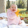 autumn, baby, blanket, child, cute, daylight, fall_leaves, grass, happy, infant, leaf, nature, outdoors, pink_jacket, playful, portrait, seasonal, smiling, tree, young