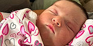 Vivian joined the competition — help win amazing prizes! baby, newborn, sleeping, onesie, heart_pattern, cozy, closeup, face, infant, child, soft, cushion, blanket, cute, peaceful, indoors, portrait, resting, young, warm