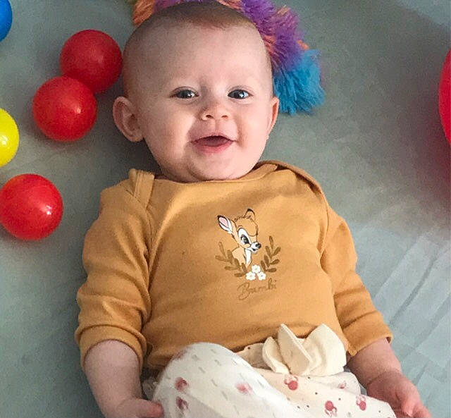 Mya participe au concours pour gagner de l'argent avec cette photo : arm, baby, baby_playing_with_toys, baby_toddler_clothing, cheek, chin, clothing, eye, face, happy, head, human_body, iris, nose, person, pink, skin, sleeve, smile, toddler