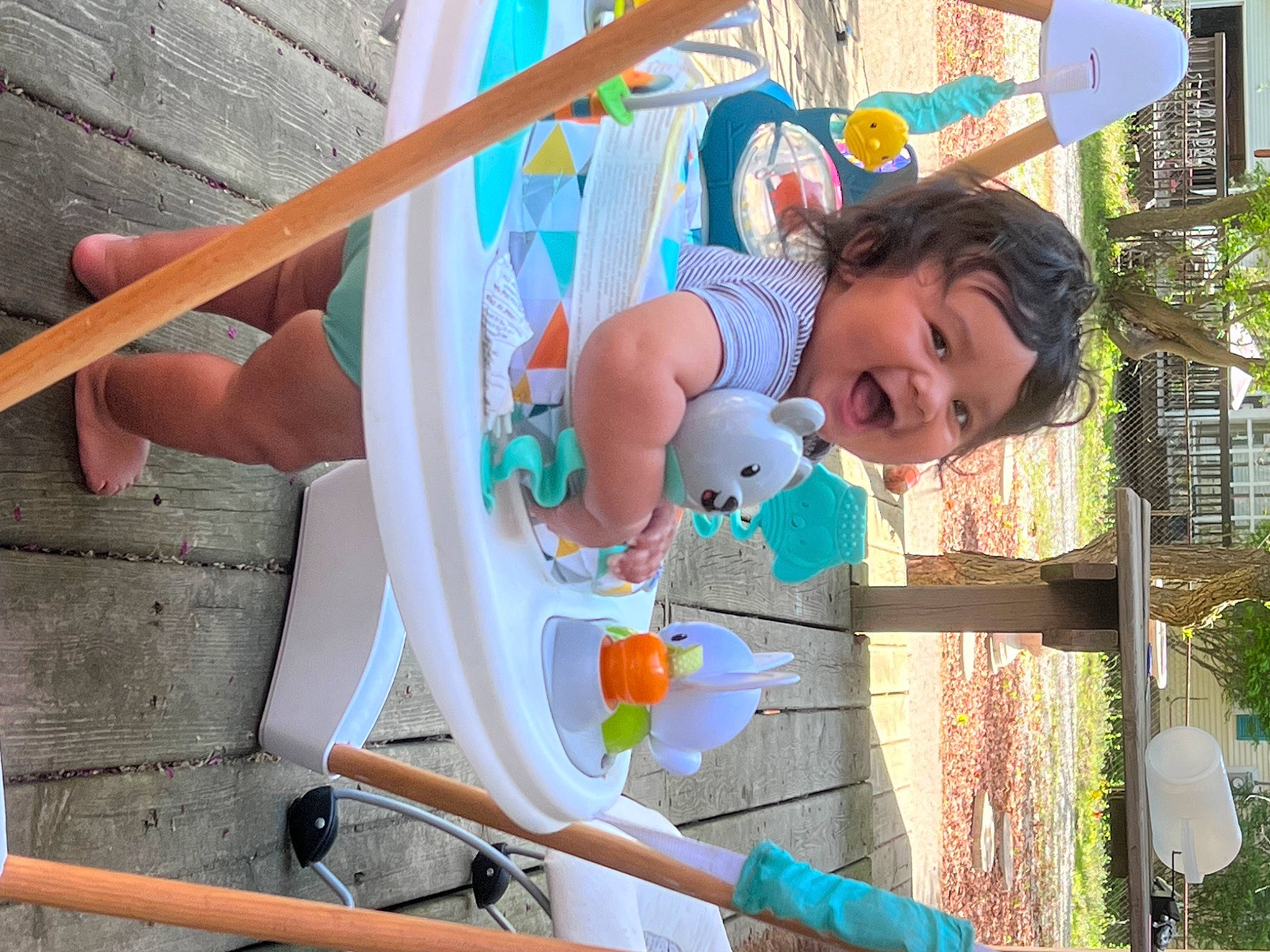 Tre is registered to the contest to win money with this photo: amusement_park, amusement_ride, baby, baby_products, child, city, fun, happy, leisure, nonbuilding_structure, outdoor_play_equipment, person, photograph, plant, play, recreation, shorts, snapshot, toddler, tree