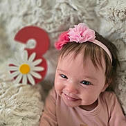 Leané joined the competition — help win amazing prizes! baby, girl, smiling, headband, flower, pink, number_three, daisy, fluffy_blanket, soft_texture, celebration, cute, portrait, closeup, happy, infant, child, indoor, cozy, toddler
