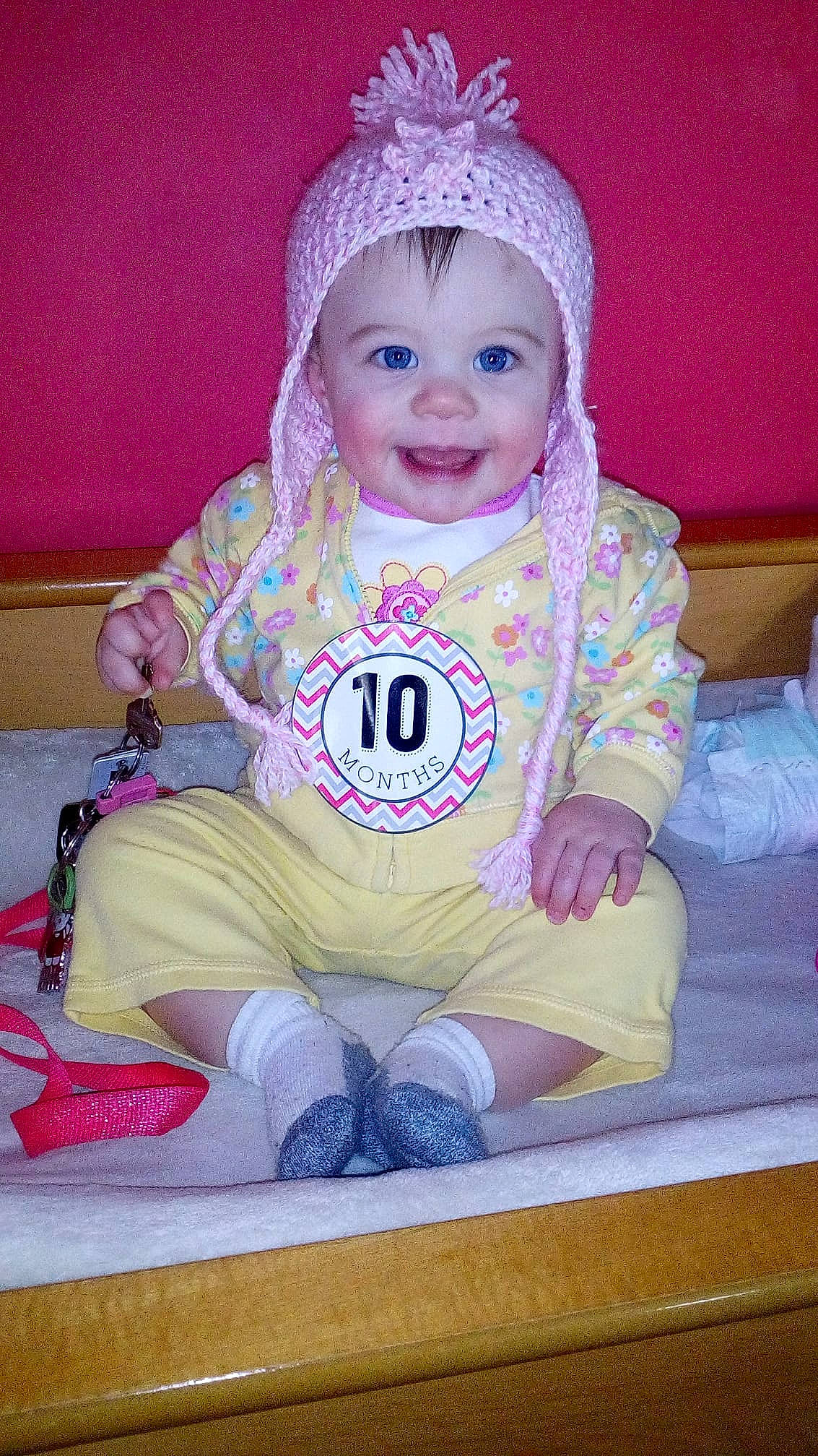 Mikenzie is registered to the contest to win money with this photo: baby_products, child, day, eye, face, facial_expression, fun, girl, hair_accessory, head, headgear, infant, iris, joy, person, pink, product, purple, sitting, skin