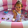 toddler, child, inflatable_pool, pink, white, water, toy, ball, curly_hair, outdoor, summer, play, cute, skin, sleeveless, expression, person, small, fun, daylight