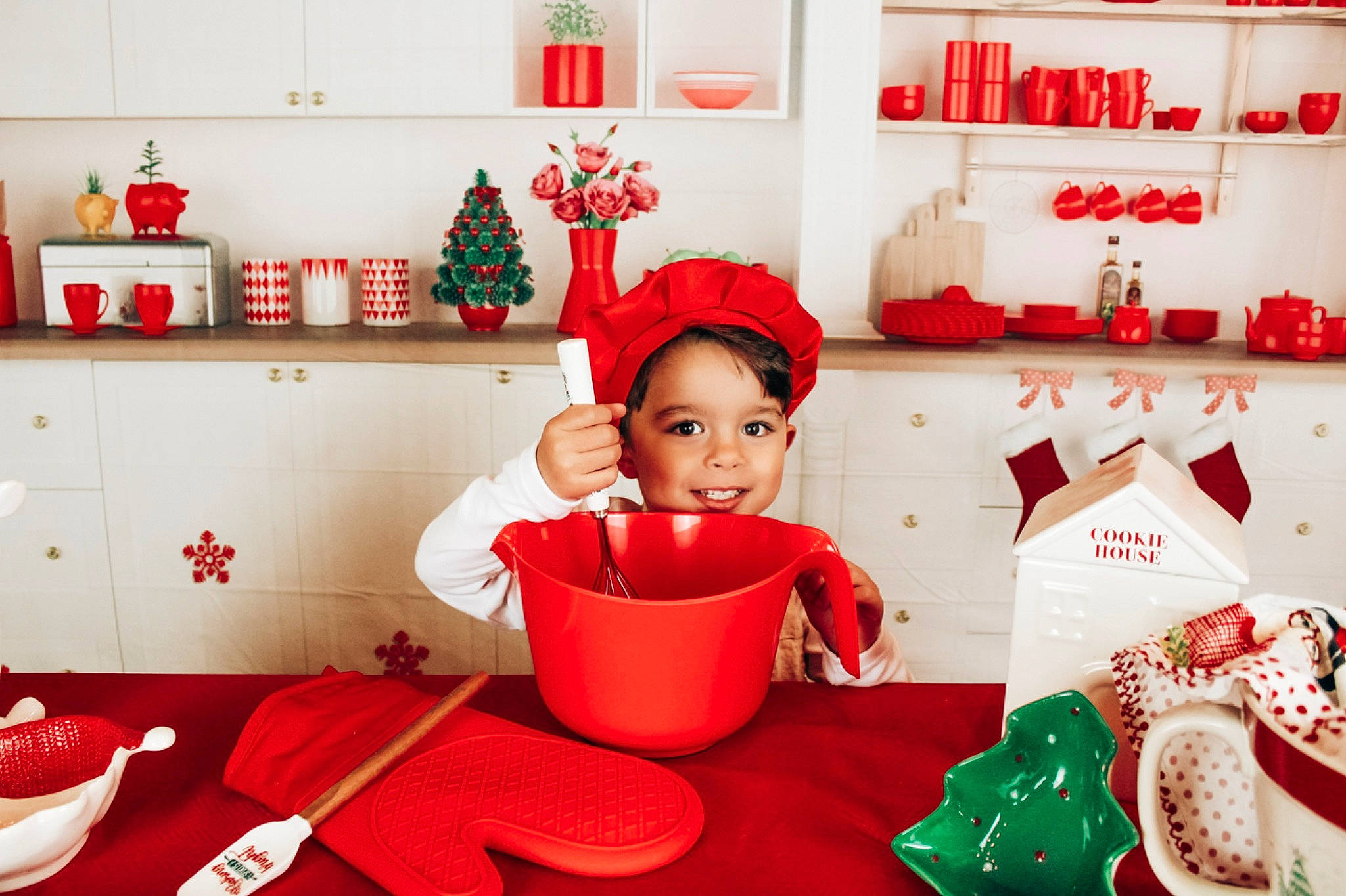 Josiah is registered to the contest to win money with this photo: carmine, christmas, christmas_decoration, christmas_eve, decoration, event, happy, headwear, holiday, interior_design, joy, lighting, ornament, person, red, room, shelf, sleeve, smile, tableware
