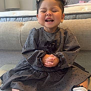 Victoria joined the competition — help win amazing prizes! toddler, child, smiling, happy, sitting, polka_dot, dress, white_shoes, hair_buns, indoor, sofa, couch, bedroom, home, cute, playful, joyful, closed_eyes, european, earrings