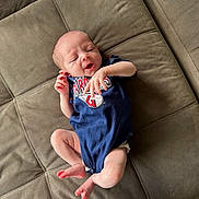 Kyleigh joined the competition — help win amazing prizes! baby, blue_clothing, couch, cushion, cute, fabric, face, foot, hand, indoors, infant, lying_down, newborn, onesie, person, relaxed, skin, sleepy, small, soft_surface