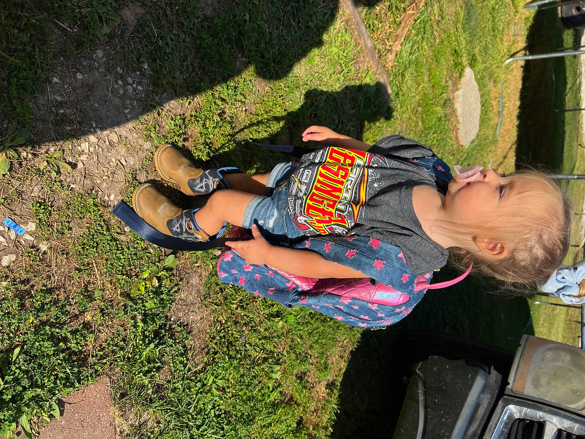 Lynnlee is registered to the contest to win money with this photo: child, fun, grass, groundcover, human_leg, leisure, people_in_nature, person, plant, recreation, shadow, sitting, soil, t_shirt, thigh, tints_and_shades, toddler, tree