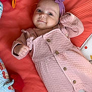 Zoélhya participe au concours pour gagner de l'argent avec cette photo : baby, infant, child, smiling, headband, pink_clothing, blanket, toy, lying_down, cute, portrait, buttoned_overall, purple_bow, indoor, soft_toys, colorful, happy, small_hands, face, cozy