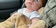 Waylon joined the competition — help win amazing prizes! baby, child, car_seat, blanket, beanie, blue_eyes, white_shirt, quilted_jacket, cozy, indoor, car_interior, seatbelt, cute, portrait, warm_clothing, infant, comfort, soft_texture, casual, resting