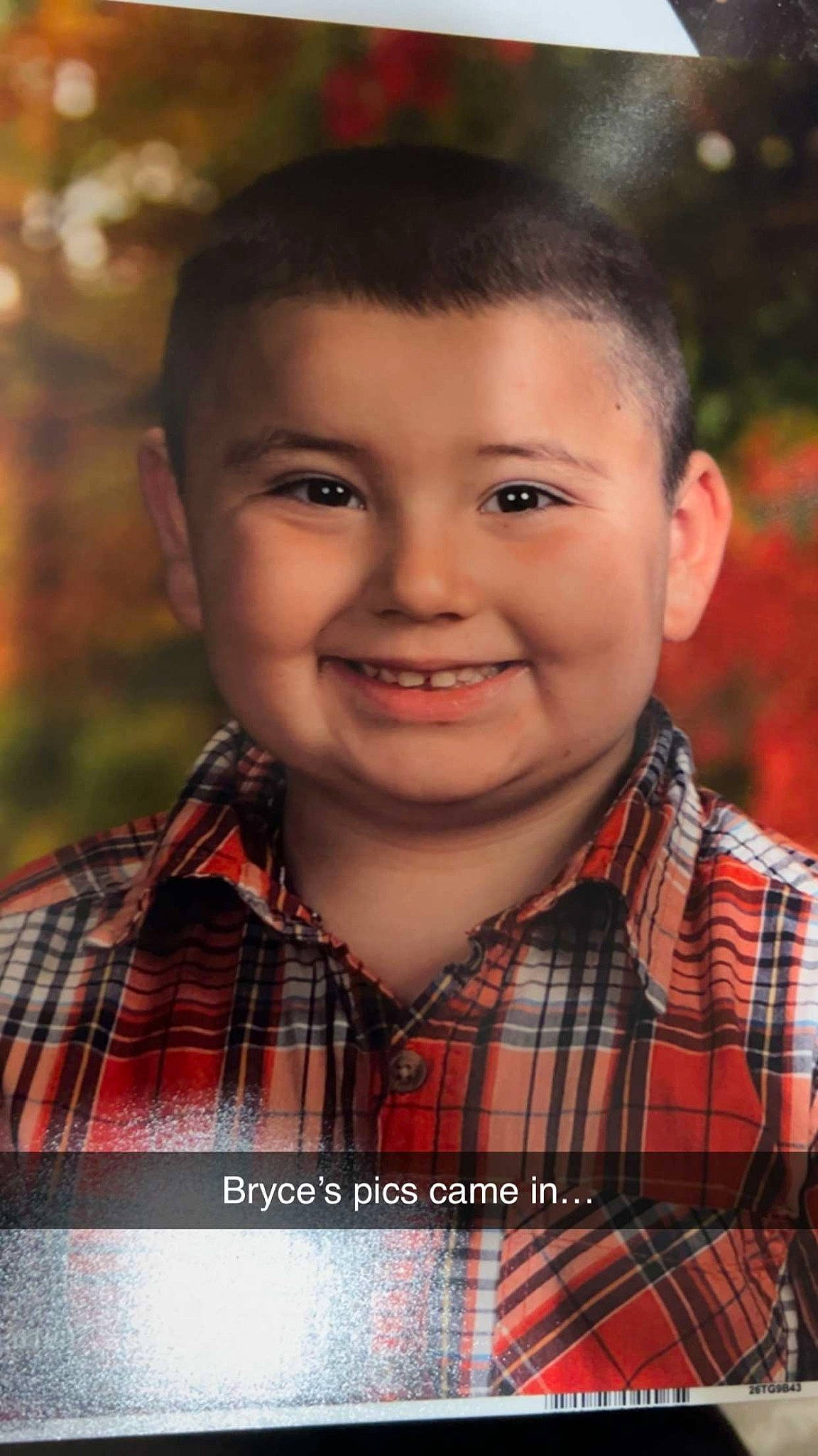 Bryce is registered to the contest to win money with this photo: cheek, chin, eye, facial_expression, flash_photography, forehead, happy, iris, joy, lip, nose, orange, people_in_nature, person, plaid, plant, shirt, skin, smile, standing