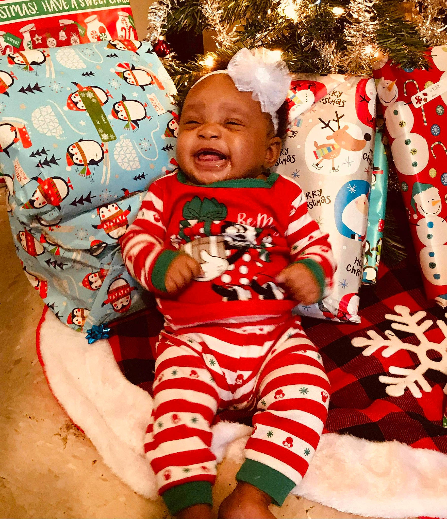 Derrianna is registered to the contest to win money with this photo: baby, baby_products, baby_toddler_clothing, child, christmas, christmas_decoration, christmas_eve, christmas_ornament, christmas_tree, holiday, holiday_ornament, laugh, nightwear, nose, opening_presents, ornament, person, pleased, present, sock