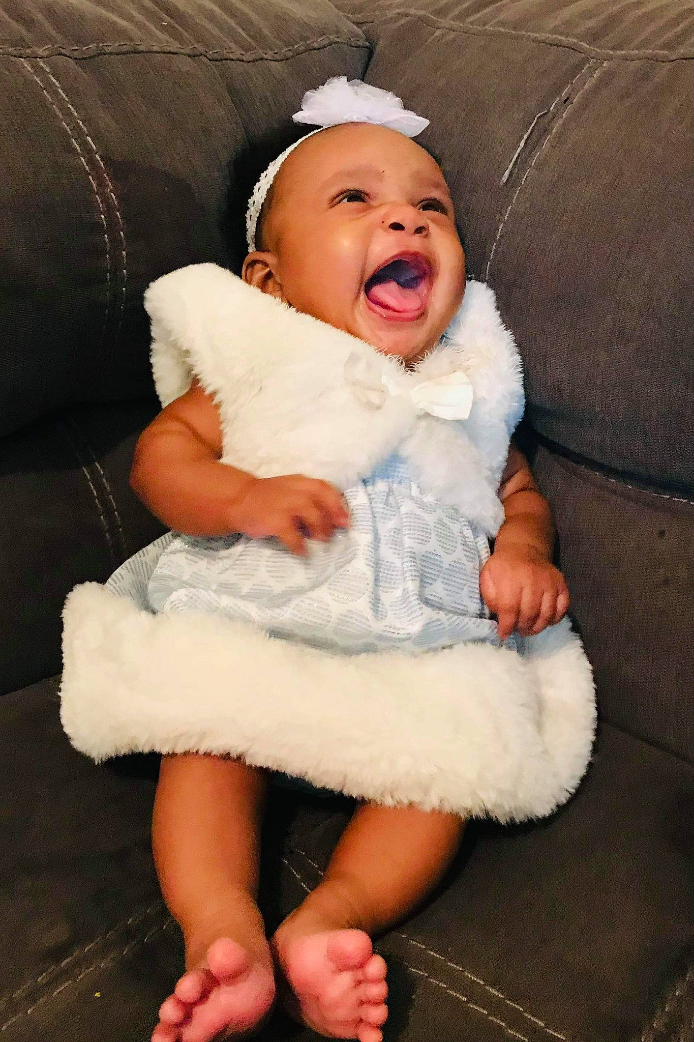 Derrianna joined the competition — help win amazing prizes! baby, baby_toddler_clothing, bonnet, comfort, costume_accessory, couch, embellishment, fur, fur_clothing, hair_accessory, headband, headpiece, living_room, natural_material, person, sitting, skin, toddler, tongue
