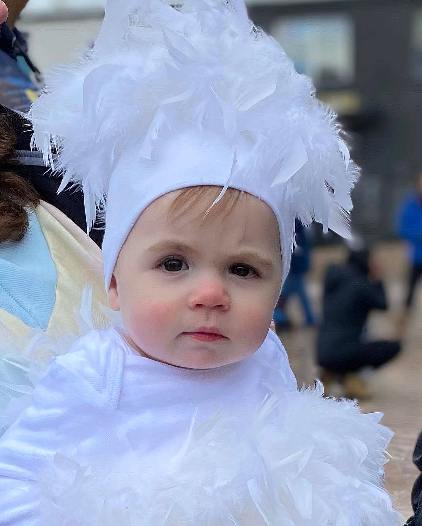 Alice is registered to the contest to win money with this photo: baby_toddler_clothing, bridal_accessory, child, costume_hat, embellishment, event, eyelash, fashion_accessory, feather, flash_photography, fun, fur, hair_accessory, happy, headgear, headpiece, headwear, person, textile, toddler