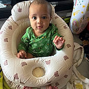 Douglas joined the competition — help win amazing prizes! baby, infant, green_clothing, inflatable_seat, bear_pattern, blanket, pillow, rainbow, indoor, curious, child, person, feet, hand, face, wide_eyes, toy, floor, cozy, playful