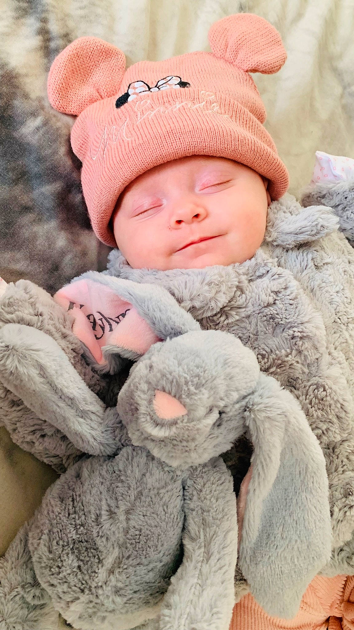 Kaylyn is registered to the contest to win money with this photo: baby, baby_sleeping, baby_toddler_clothing, cap, cheek, child, comfort, fur, grey, hat, headgear, headwear, knit_cap, linens, outerwear, person, pink, skin, sleeve, textile