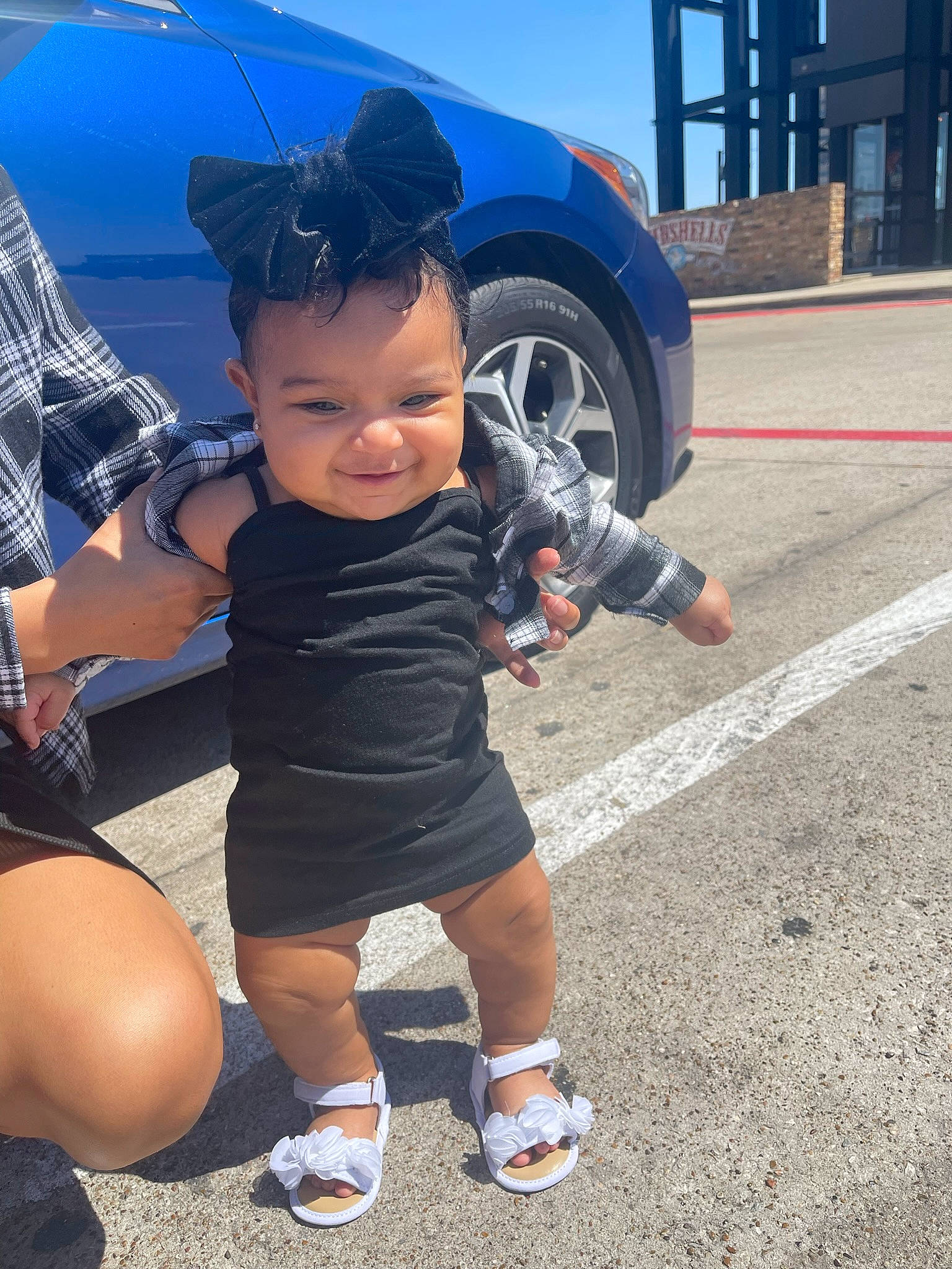 Indie joined the competition — help win amazing prizes! asphalt, automotive_design, automotive_exterior, automotive_lighting, automotive_tire, blue, bumper, car, footwear, hat, hood, joy, motor_vehicle, person, shoe, shorts, smile, sneakers, tire, vehicle