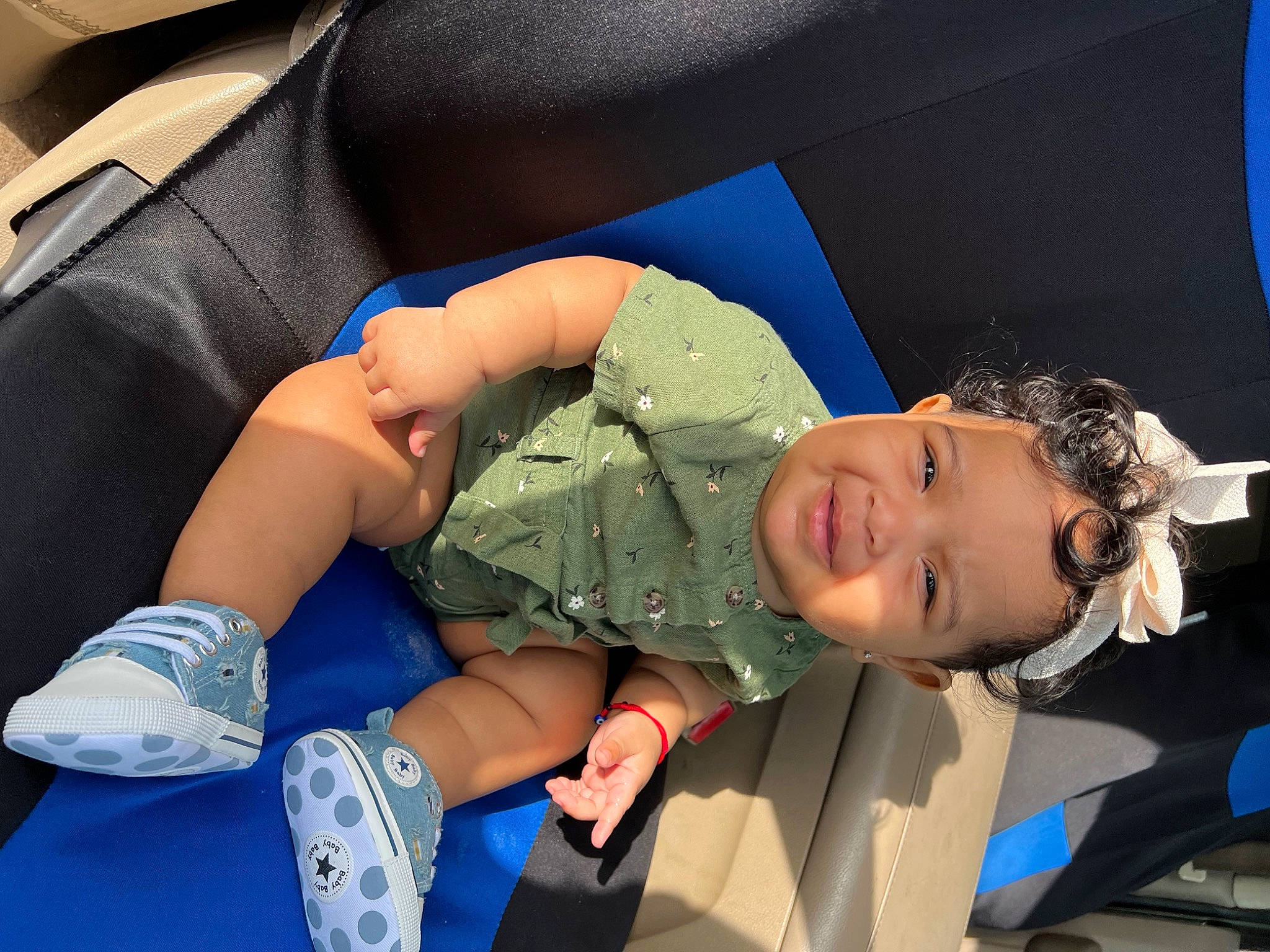 Indie is registered to the contest to win money with this photo: arm, baby, blue, comfort, elbow, electric_blue, glove, headwear, health_care, human_body, human_leg, joint, knee, leg, leisure, person, shorts, smile, sneakers, sock