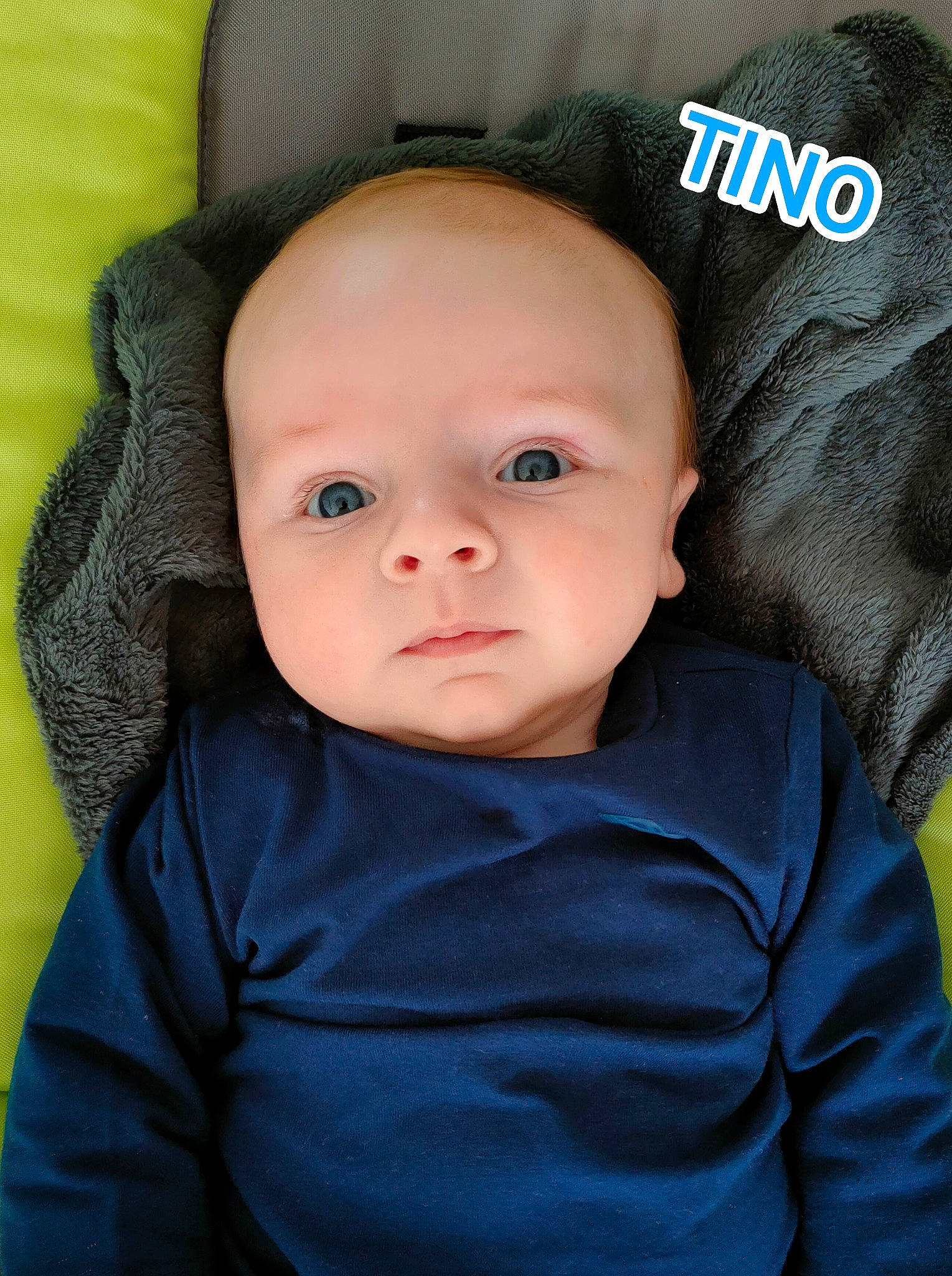 Tino participe au concours pour gagner de l'argent avec cette photo : baby, baby_products, baby_toddler_clothing, cap, cheek, child, comfort, electric_blue, eyebrow, eyelash, hat, headgear, human, nose, outerwear, person, product, sitting, sleeve, textile