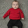 baby, black_pants, blue_eyes, carpet, casual_clothing, child, cute, fashion, floor, footwear, indoor, infant, lying_down, person, portrait, red_boots, red_sweater, serious_expression, short_hair, textured_carpet