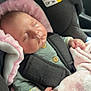 baby, blanket, car, car_seat, child, clothing, cozy, cute, head_support, indoors, infant, newborn, peaceful, pink, resting, safety_harness, seatbelt, sleeping, soft_texture, tiny_hand