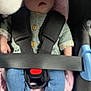 Esmée participe au concours pour gagner de l'argent avec cette photo : baby, blue_jeans, buttons, car_seat, child, closeup, clothing, cute, green_shirt, indoors, infant, peaceful, person, resting, safety, seatbelt, sleeping, socks, soft_padding, toy