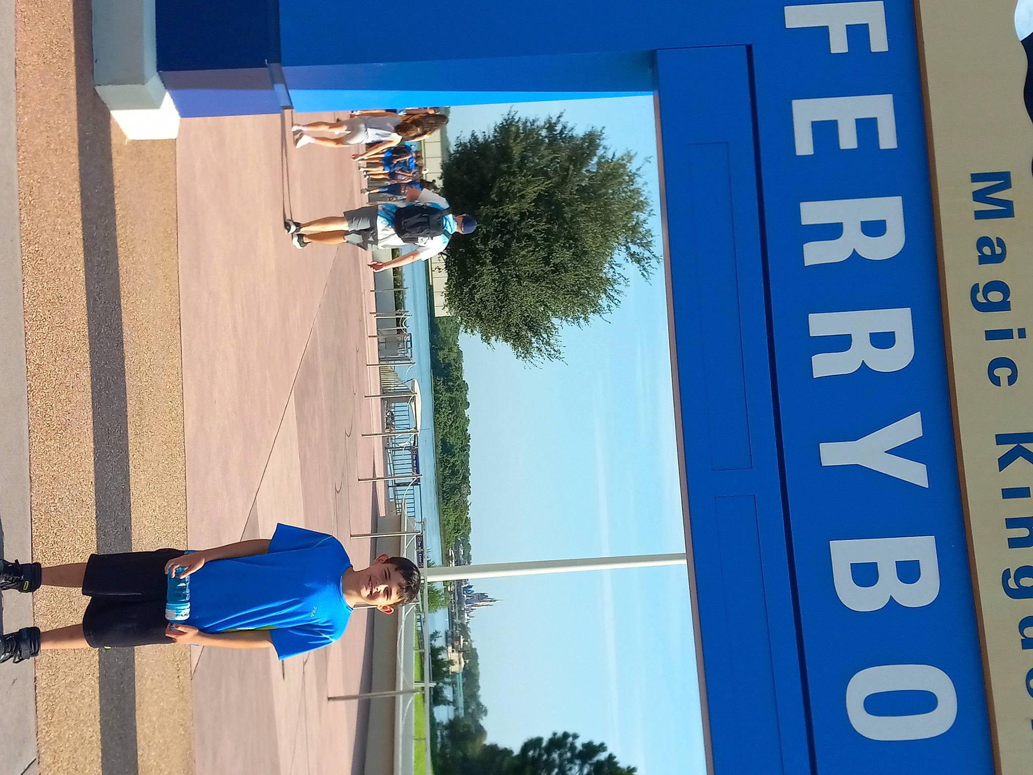 Christopher is registered to the contest to win money with this photo: advertising, architecture, azure, blue, daytime, elbow, electric_blue, facade, joy, leisure, line, person, photograph, pole, property, recreation, sky, snapshot, tree, wall