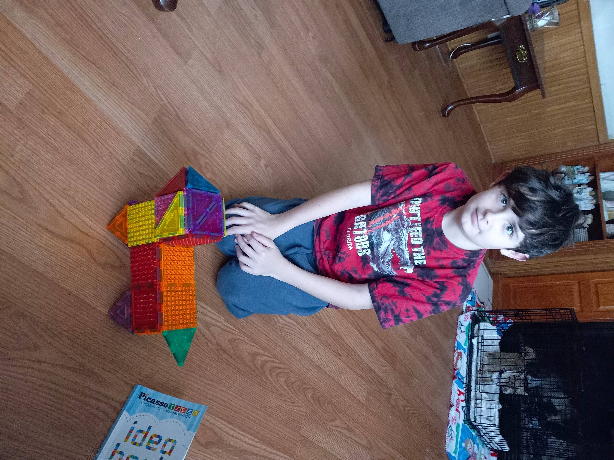 Christopher joined the competition — help win amazing prizes! child, flooring, fun, happy, hardwood, paper_product, pattern, person, room, sitting, smile, t_shirt, toddler, varnish, wood, wood_stain