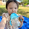 Clementine joined the competition — help win amazing prizes! baby, blanket, blue_sippy_cup, child, cute, daylight, drinking, face, grass, hand, nature, outdoor, patterned_clothing, person, playtime, portrait, short_sleeve_shirt, summer, toddler, young_child