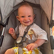 Tommy joined the competition — help win amazing prizes! baby, child, clothing, cute, expression, face, hand, happy, head, ice_cream_patch, infant, outdoor, person, seatbelt, smiling, stroller, sunlight, toddler, white_shirt, yellow_pants