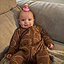 Tommy joined the competition — help win amazing prizes! baby, child, onesie, brown_clothing, bear_print, rubber_duck, pink_duck, hat, straw_hat, couch, blanket, smile, face, infant, indoors, cozy, soft_furniture, cute, relaxed, portrait