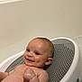 Tommy is registered to the contest to win money with this photo: baby, infant, bath, bathroom, smile, skin, water, plastic, seat, child, young, person, cute, happy, relaxing, indoors, head, face, arm, human