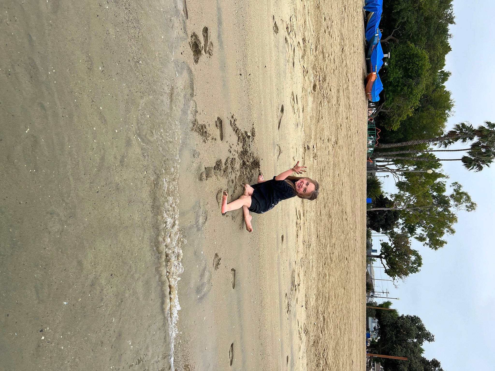 Scarlett is registered to the contest to win money with this photo: beach, coast, concrete, extreme_sport, fun, happy, joy, landscape, leisure, people_in_nature, person, plant, recreation, rock, shadow, sky, sport_climbing, tree, trunk, wall