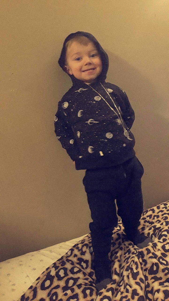 Stephen is registered to the contest to win money with this photo: cheek, child, face, jacket, jeans, joy, leggings, outerwear, pattern, person, shoe, sleeve, smile, standing, tights, toddler